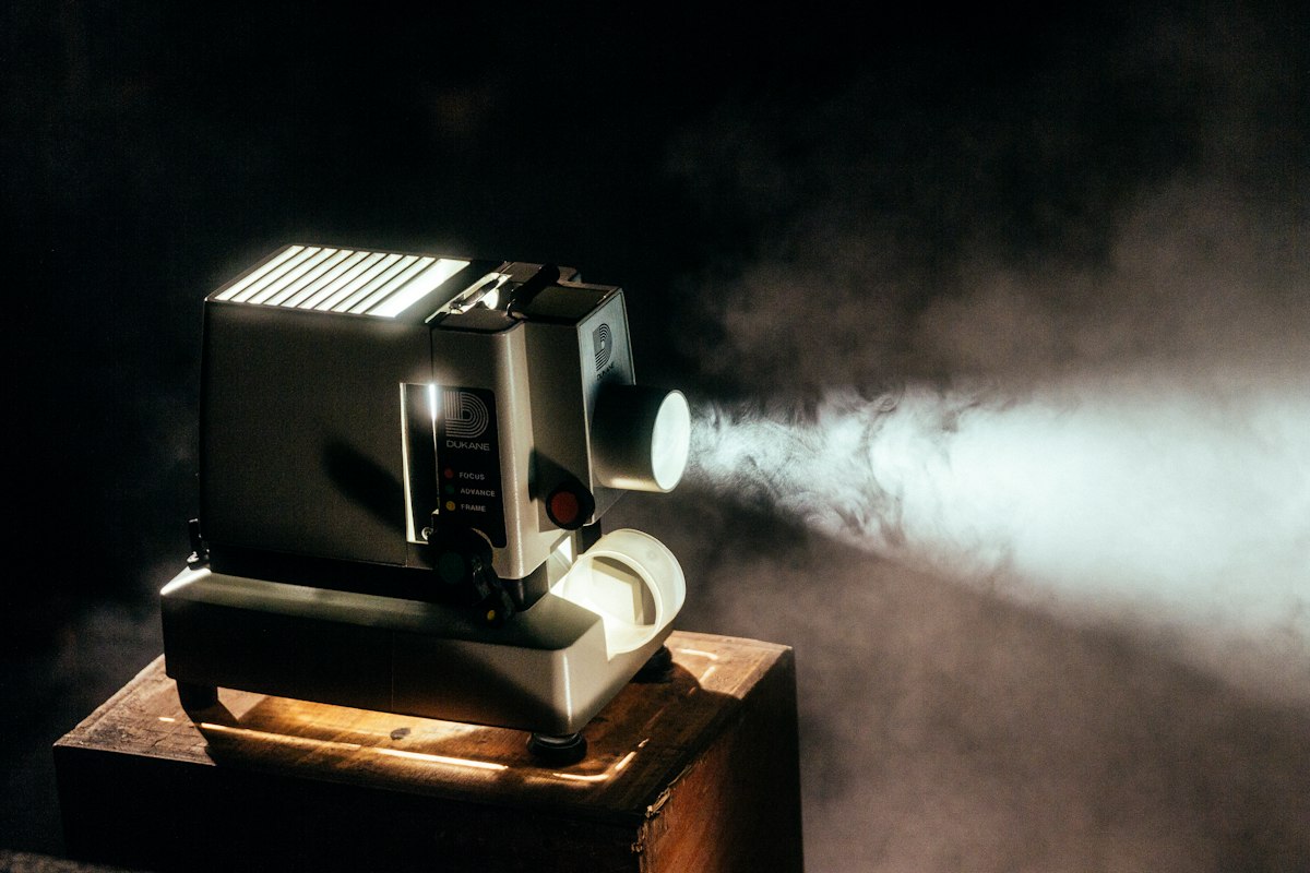 Cinematic projector light streaming a movie in the dark